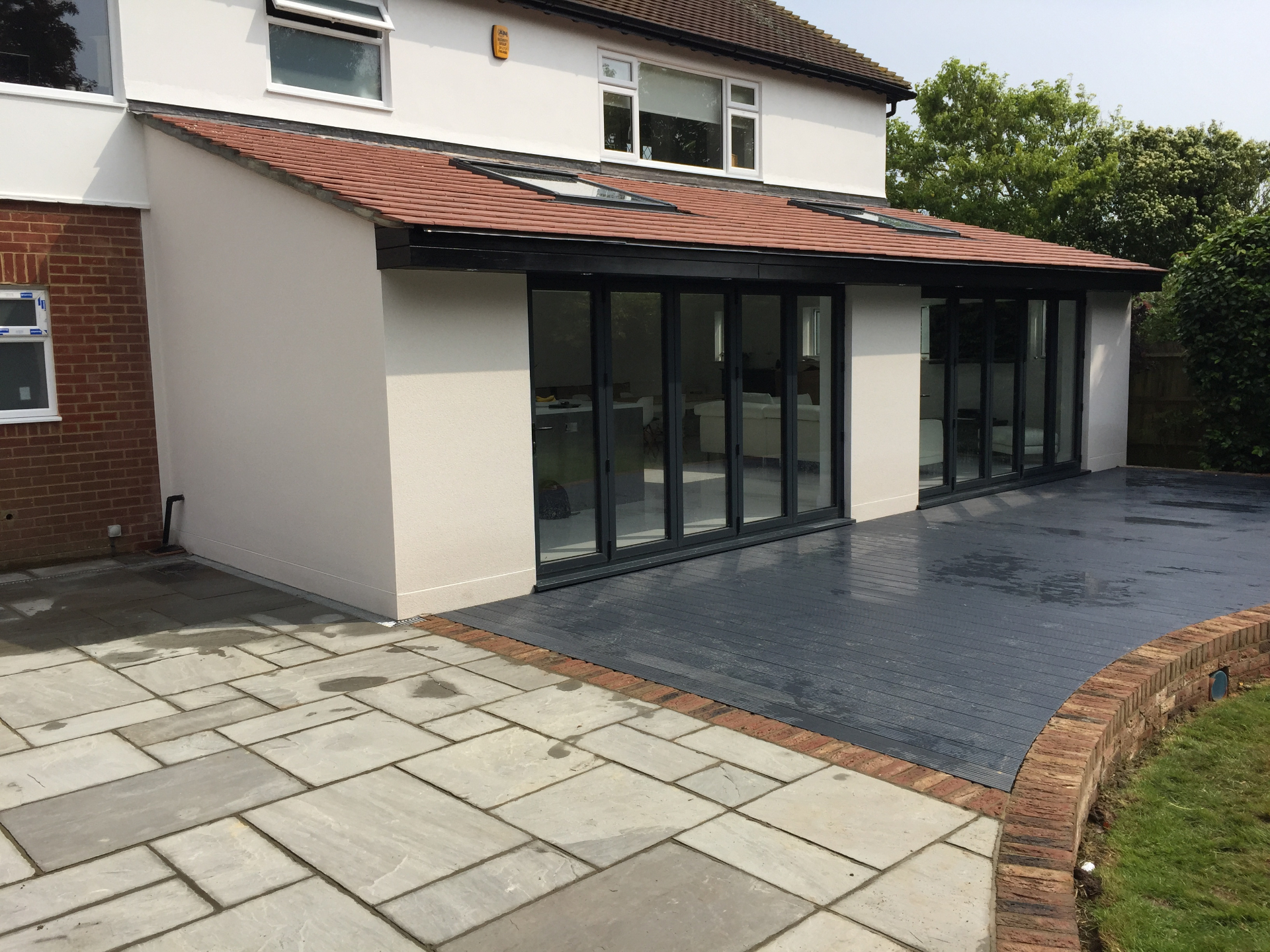Composite decking and natural stone patio installation in East Sussex
