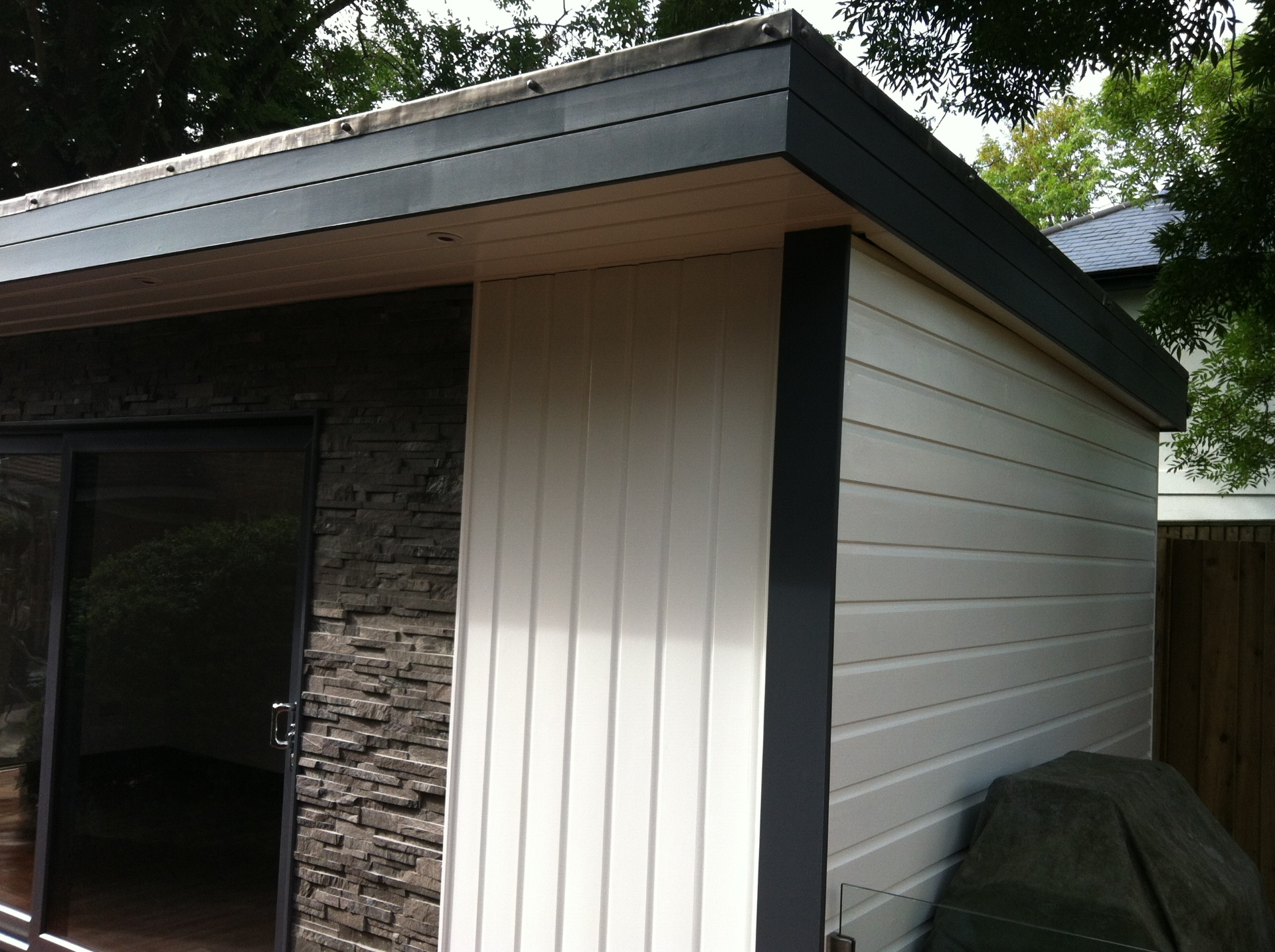 Garage conversion exterior showing new windows and rendered finish