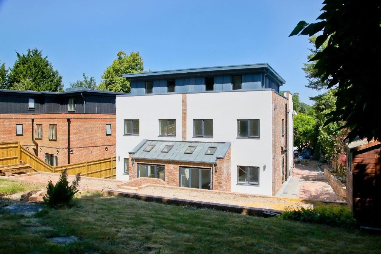 Rear view of new build home with landscaped garden and patio by Masters Group