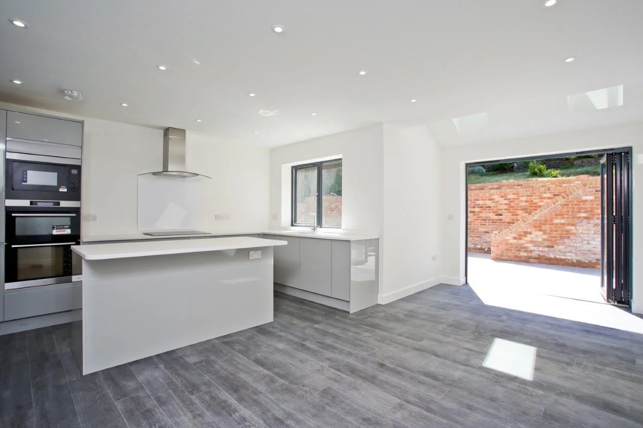 New build property side view showing modern render and anthracite windows